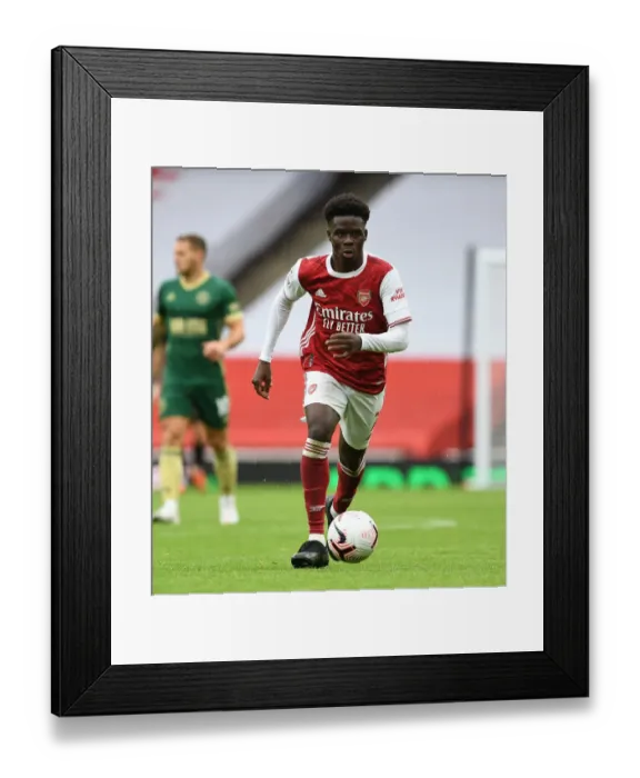 Framed Print : Arsenal's Bukayo Saka in Action Against Sheffield United in Empty Emirates Stadium (2020-21) Framed Print : Arsenal's Bukayo Saka in Action Against Sheffield United in Empty Emirates Stadium (2020-21)
