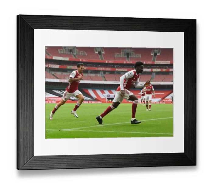 Framed Print : LONDON, ENGLAND - OCTOBER 04: Bukayo Saka celebrates scorign the 1st Arsenal goal during the Premier League match