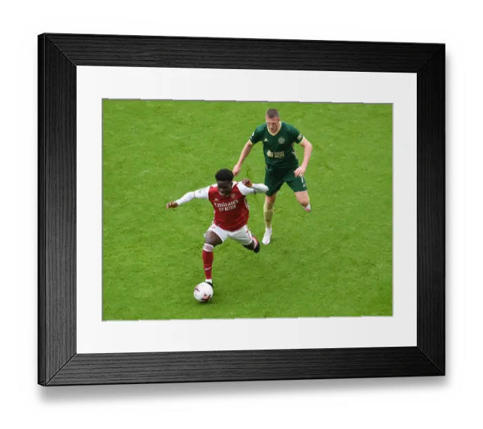 Framed Print : Arsenal's Bukayo Saka Clashes with Sheffield United's John Lundstram in Premier League Showdown Framed Print : Arsenal's Bukayo Saka Clashes with Sheffield United's John Lundstram in Premier League Showdown