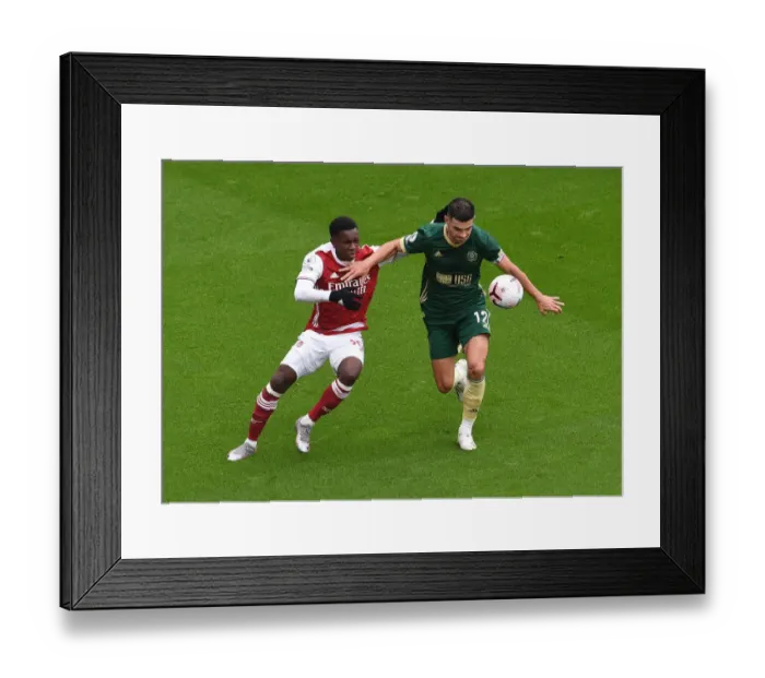 Framed Print : Arsenal vs Sheffield United: Eddie Nketiah Clashes with John Egan in Premier League Showdown