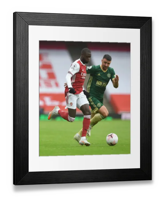 Framed Print : Arsenal's Pepe Clashes with Stevens in Premier League Showdown: Arsenal v Sheffield United (2020-21)