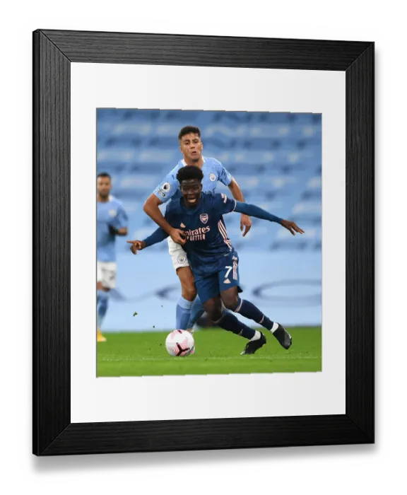 Framed Print : Saka vs Rodrigo: A Premier League Battle at Etihad Stadium (2020-21) Framed Print : Saka vs Rodrigo: A Premier League Battle at Etihad Stadium (2020-21)