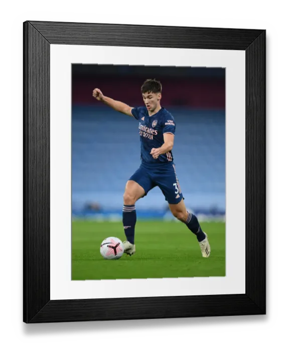 Framed Print : Arsenal's Kieran Tierney Goes Head-to-Head with Manchester City in Premier League Battle