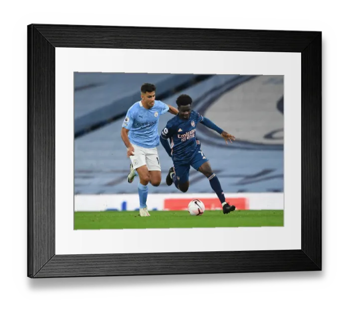 Framed Print : Saka vs Rodrigo: A Premier League Showdown - Bukayo Saka of Arsenal Clashes with Manchester City's Rodrigo (2020-21) Framed Print : Saka vs Rodrigo: A Premier League Showdown - Bukayo Saka of Arsenal Clashes with Manchester City's Rodrigo (2020-21)