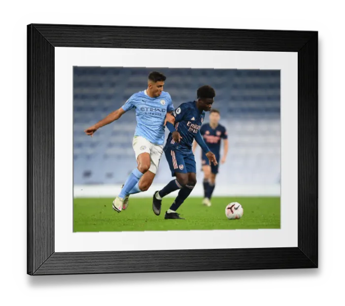 Framed Print : Clash of Young Titans: Bukayo Saka vs Rodrigo - Manchester City vs Arsenal, Premier League 2020-21 (Empty Etihad Stadium) Framed Print : Clash of Young Titans: Bukayo Saka vs Rodrigo - Manchester City vs Arsenal, Premier League 2020-21 (Empty Etihad Stadium)