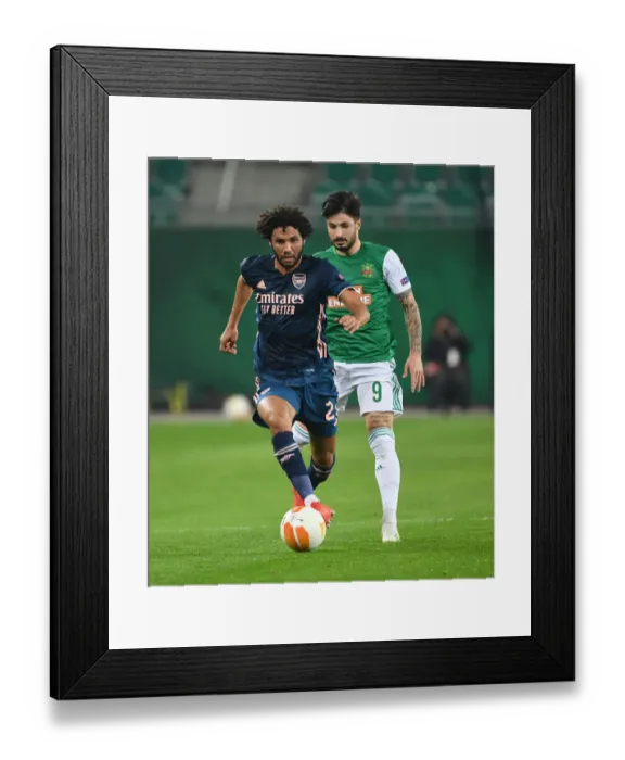 Framed Print : Mo Elneny Breaks Past Rapid Wien's Taxiarchis Fountas in Arsenal's UEFA Europa League Clash Framed Print : Mo Elneny Breaks Past Rapid Wien's Taxiarchis Fountas in Arsenal's UEFA Europa League Clash