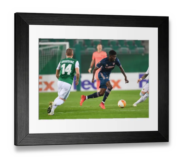 Framed Print : Thomas Partey Breaks Past Rapid Wien's Defense in Arsenal's Europa League Clash Framed Print : Thomas Partey Breaks Past Rapid Wien's Defense in Arsenal's Europa League Clash