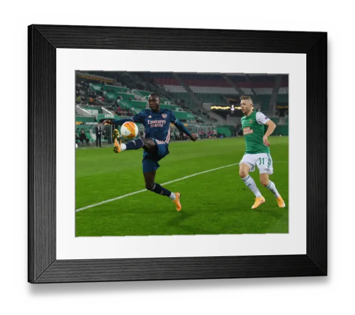 Framed Print : Arsenal's Nicolas Pepe in Action: Rapid Vienna vs Arsenal, Europa League 2020-21