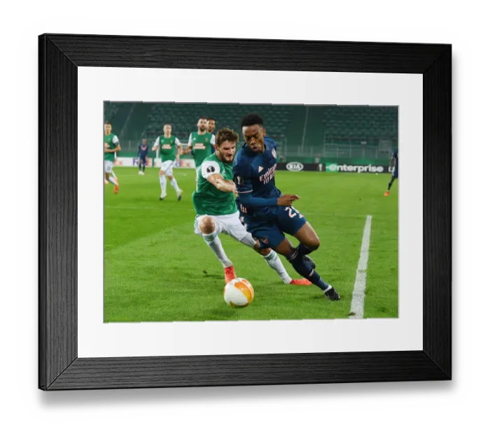 Framed Print : Arsenal's Joe Willock Breaks Past Rapid Wien's Maximilian Hofmann in Europa League Clash Framed Print : Arsenal's Joe Willock Breaks Past Rapid Wien's Maximilian Hofmann in Europa League Clash