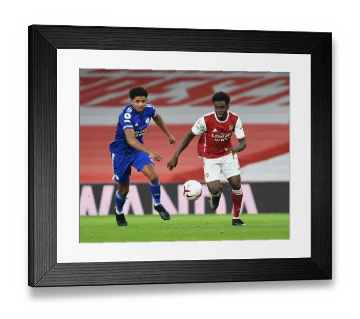 Framed Print : Arsenal's Bukayo Saka Outwits Leicester's James Justin in Empty Emirates Stadium