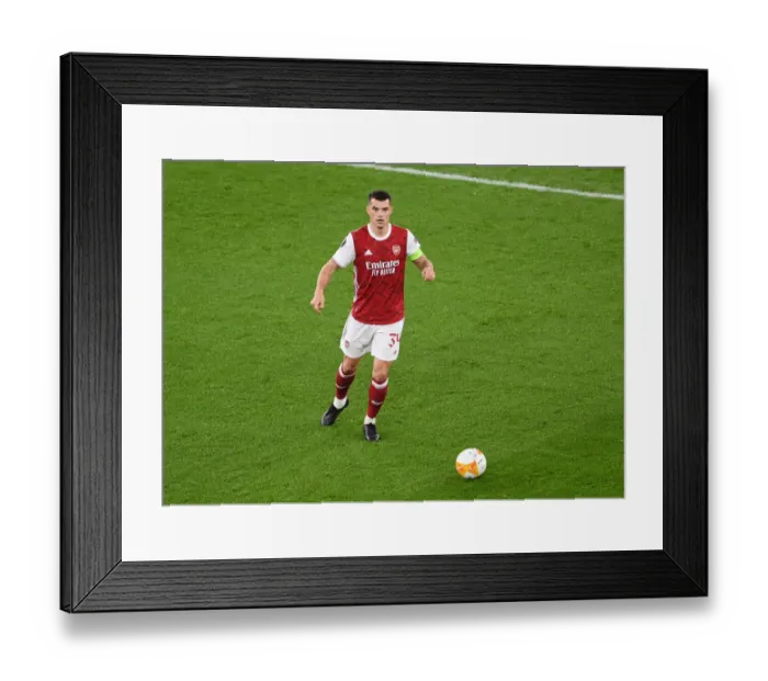 Framed Print : Granit Xhaka Plays Alone: Arsenal's Empty Emirates Stadium in UEFA Europa League Match against Dundalk