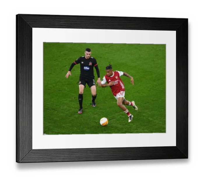 Framed Print : Reiss Nelson vs. Michael Duffy: A Rivalry Unfolds in Empty Emirates Stadium - UEFA Europa League 2020-21