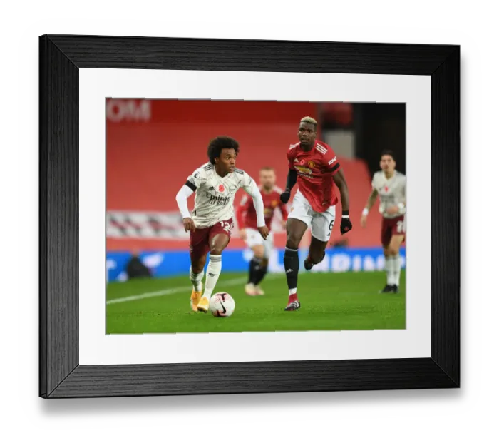 Framed Print : Willian vs. Pogba: A Battle at Empty Old Trafford - Manchester United vs. Arsenal, Premier League (2020-21)