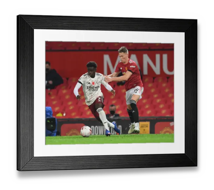 Framed Print : Empty Old Trafford Showdown: Bukayo Saka vs Scott McTominay, Manchester United vs Arsenal, Premier League 2020-21