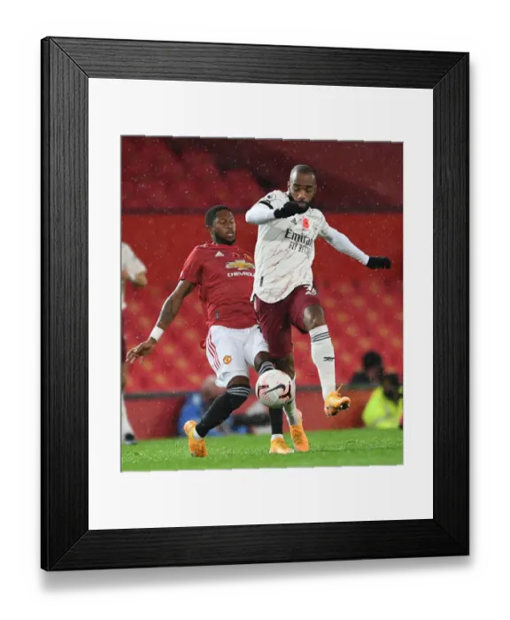 Framed Print : Lacazette vs Fred: Premier League Clash at Empty Old Trafford (2020-21)
