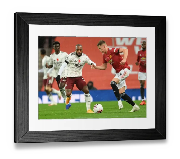 Framed Print : Arsenal's Lacazette Closes In On Manchester United's McTominay In Empty Old Trafford Framed Print : Arsenal's Lacazette Closes In On Manchester United's McTominay In Empty Old Trafford