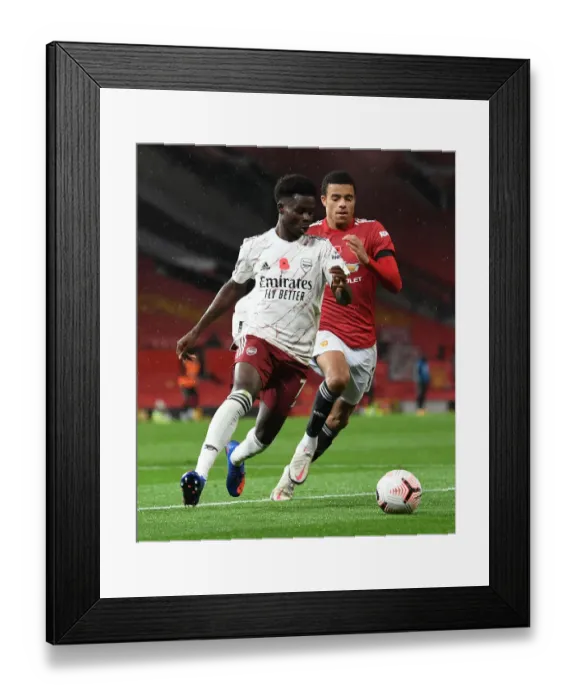 Framed Print : Manchester United vs Arsenal: Bukayo Saka vs Mason Greenwood Clash in Empty Old Trafford Framed Print : Manchester United vs Arsenal: Bukayo Saka vs Mason Greenwood Clash in Empty Old Trafford