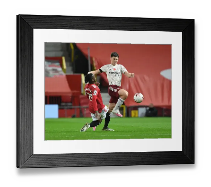 Framed Print : Manchester United vs Arsenal: Tierney vs Wan-Bissaka Clash in Empty Old Trafford