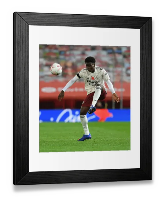 Framed Print : Bukayo Saka: Arsenal's Radiant Star Shines at Old Trafford Amidst Empty Seats, Manchester United vs. Arsenal, 2020-21 Premier League Framed Print : Bukayo Saka: Arsenal's Radiant Star Shines at Old Trafford Amidst Empty Seats, Manchester United vs. Arsenal, 2020-21 Premier League