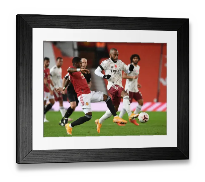 Framed Print : Lacazette vs Fred: Empty Old Trafford Showdown - Premier League 2020-21: Manchester United vs Arsenal