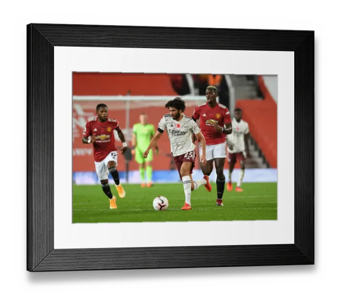 Framed Print : Arsenal's Mo Elneny Outsmarts Paul Pogba: A Battle in Empty Old Trafford