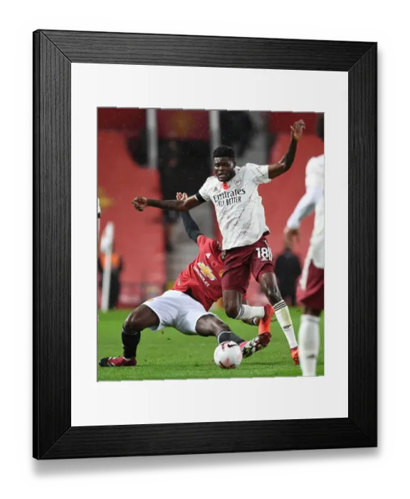 Framed Print : Manchester United vs. Arsenal: Thomas Partey Fouls by Pogba Amid Empty Old Trafford Stands (2020-21 Premier League) Framed Print : Manchester United vs. Arsenal: Thomas Partey Fouls by Pogba Amid Empty Old Trafford Stands (2020-21 Premier League)