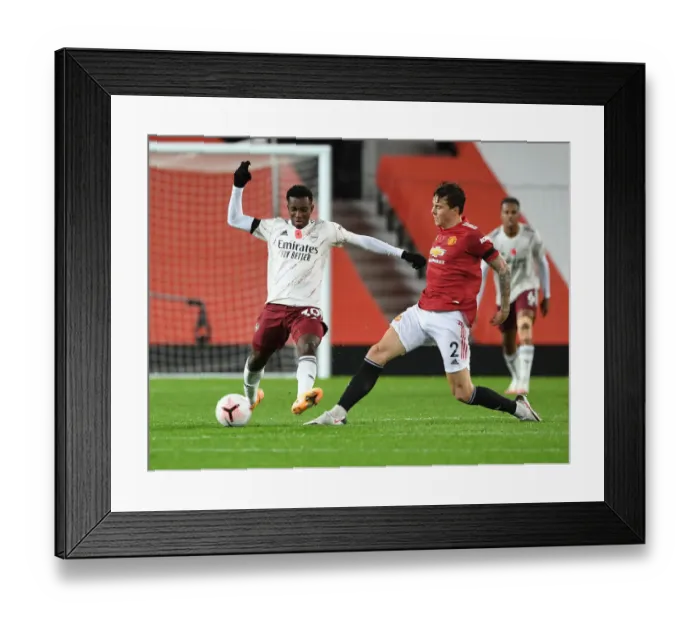 Framed Print : Nketiah vs Lindelof: A Battle at Empty Old Trafford - Premier League 2020-21