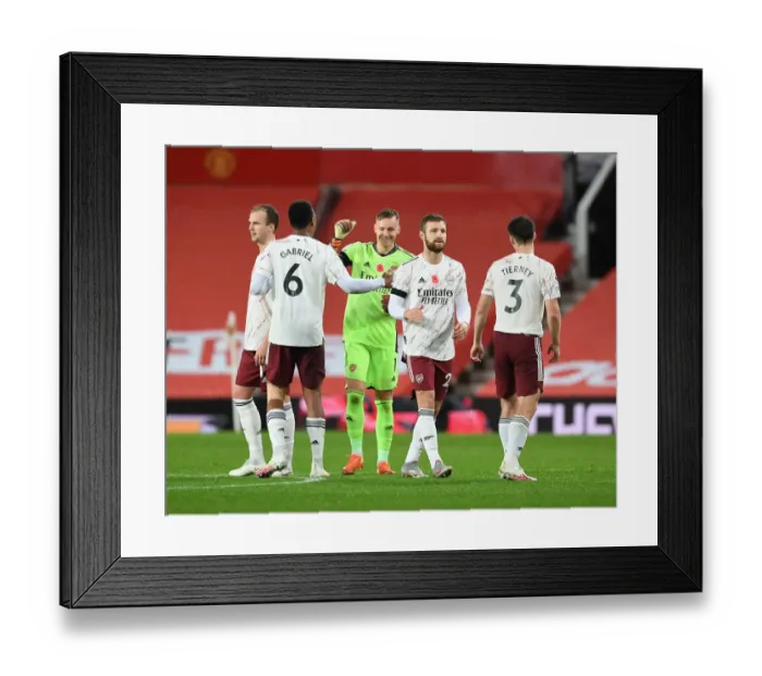 Framed Print : Arsenal Players Unite at Old Trafford Amidst Empty Stands - Manchester United vs Arsenal, 2020-21 Premier League