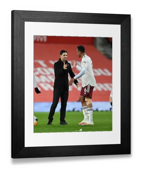 Framed Print : Arsenal's Victory at Old Trafford: Mikel Arteta Congratulates Gabriel