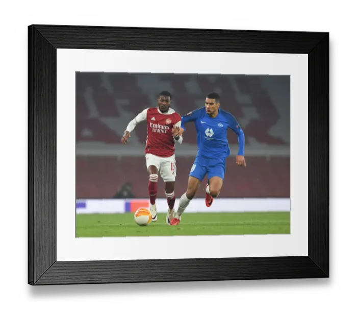 Framed Print : Arsenal's Ainsley Maitland-Niles Breaks Past Molde's Omoijuanfo in Europa League Clash Framed Print : Arsenal's Ainsley Maitland-Niles Breaks Past Molde's Omoijuanfo in Europa League Clash