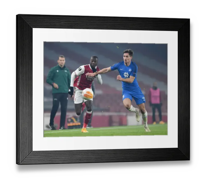 Framed Print : Arsenal's Nicolas Pepe Faces Off Against Molde's Kristoffer Haugen in Europa League Clash Framed Print : Arsenal's Nicolas Pepe Faces Off Against Molde's Kristoffer Haugen in Europa League Clash
