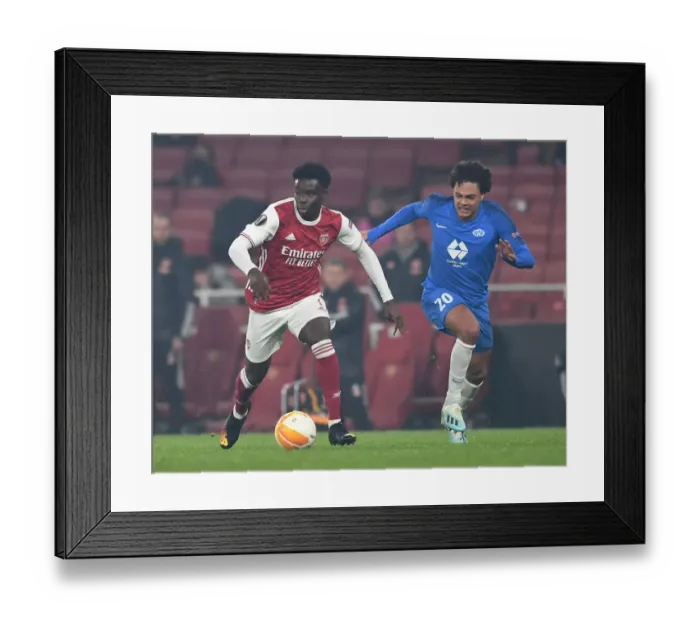 Framed Print : Arsenal's Bukayo Saka Clashes with Molde's Henry Wingo in Europa League Showdown