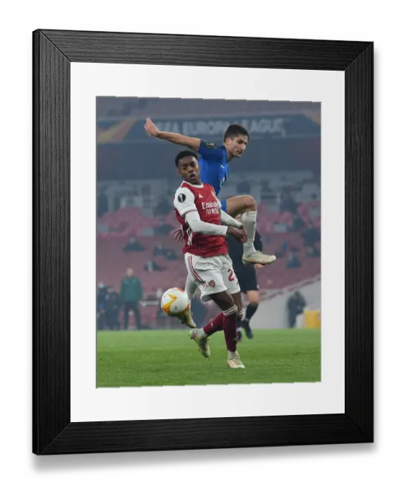Framed Print : Arsenal's Joe Willock Faces Off Against Kristoffer Haugen in Europa League Clash Framed Print : Arsenal's Joe Willock Faces Off Against Kristoffer Haugen in Europa League Clash