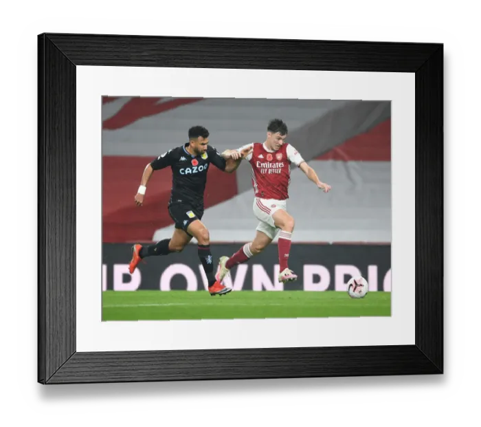 Framed Print : Arsenal's Kieran Tierney Outruns Aston Villa's Trezeguet in Empty Emirates Stadium