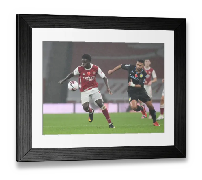 Framed Print : Arsenal vs Aston Villa: Saka vs Trezeguet Clash in Empty Emirates Stadium, Premier League 2020-21
