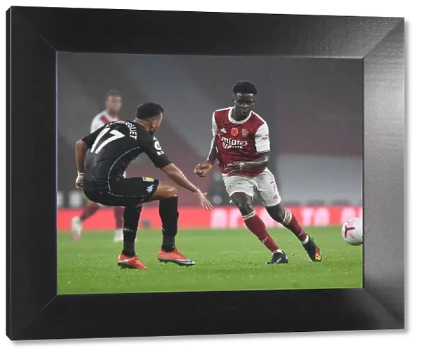 Arsenal's Bukayo Saka in Action: Premier League Showdown at Empty Emirates Stadium (Arsenal vs Aston Villa, 2020-21)