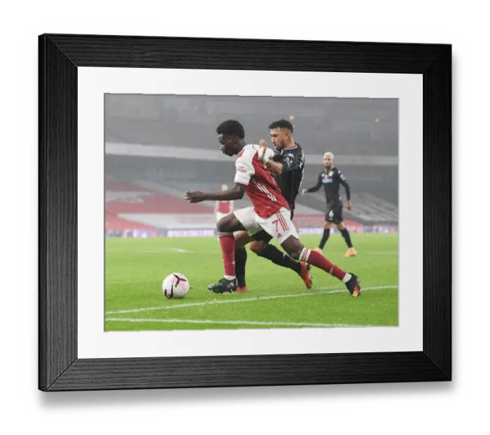 Framed Print : Arsenal vs Aston Villa: Saka Takes on Trezeguet in Empty Emirates Stadium, Premier League 2020-21 Framed Print : Arsenal vs Aston Villa: Saka Takes on Trezeguet in Empty Emirates Stadium, Premier League 2020-21