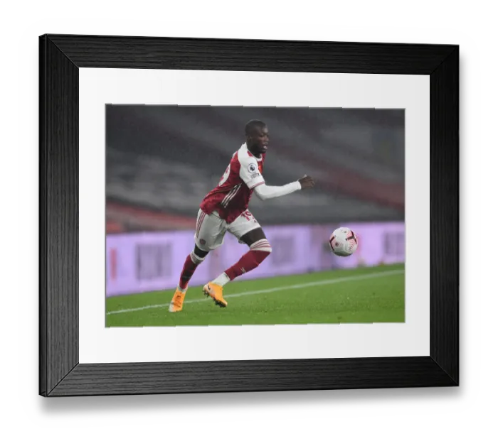 Framed Print : Arsenal's Nicolas Pepe in Action against Aston Villa in the Premier League (2020-21)