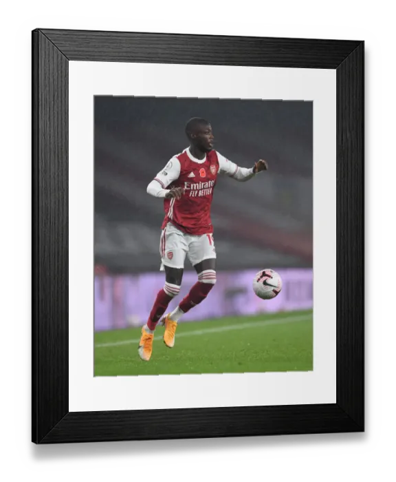 Framed Print : Arsenal's Nicolas Pepe in Action against Aston Villa - Premier League 2020-21