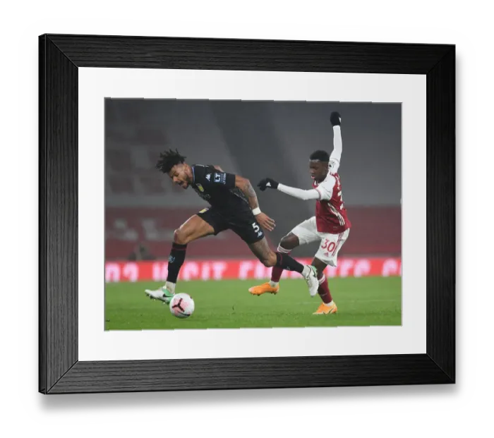 Framed Print : Arsenal vs Aston Villa: Eddie Nketiah Clashes with Tyrone Mings in Premier League Showdown