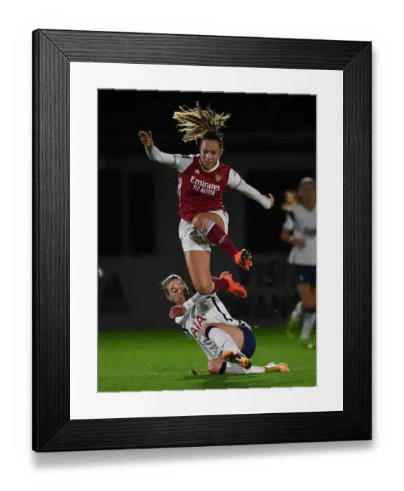 Framed Print : Arsenal vs. Tottenham Women's FA Cup Clash: Lia Walti Leaps Over Alanna Kennedy Amid Empty Stands