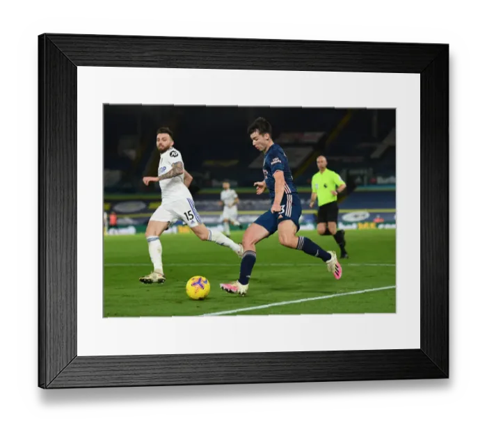 Framed Print : Arsenal's Kieran Tierney Faces Off Against Leeds Stuart Dallas in Premier League Clash