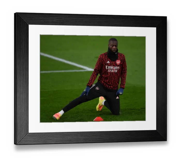 Framed Print : Arsenal's Nicolas Pepe Warming Up Ahead of Leeds United Clash - Premier League 2020-21