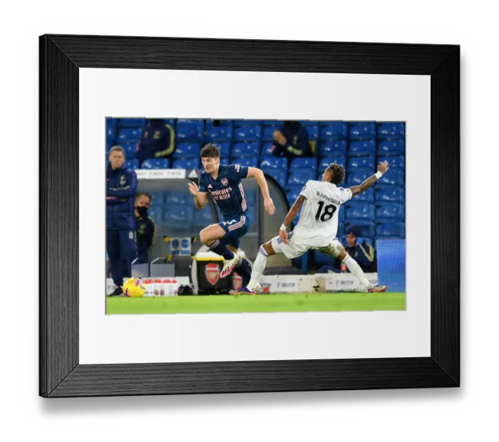 Framed Print : Arsenal's Kieran Tierney Clashes with Raphinha in Leeds United vs Arsenal Premier League Showdown