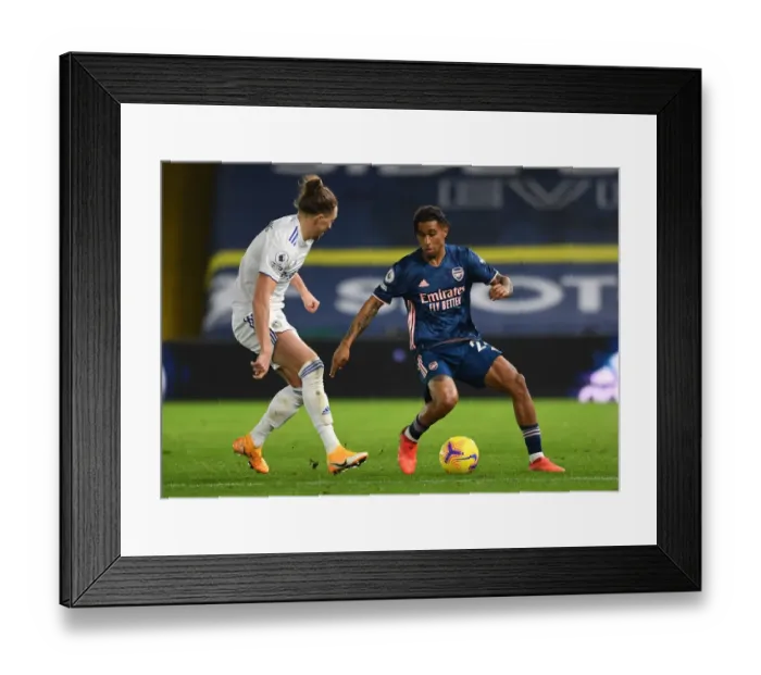 Framed Print : Reiss Nelson vs Luke Ayling: Battle at Elland Road - Leeds United vs Arsenal, Premier League 2020-21