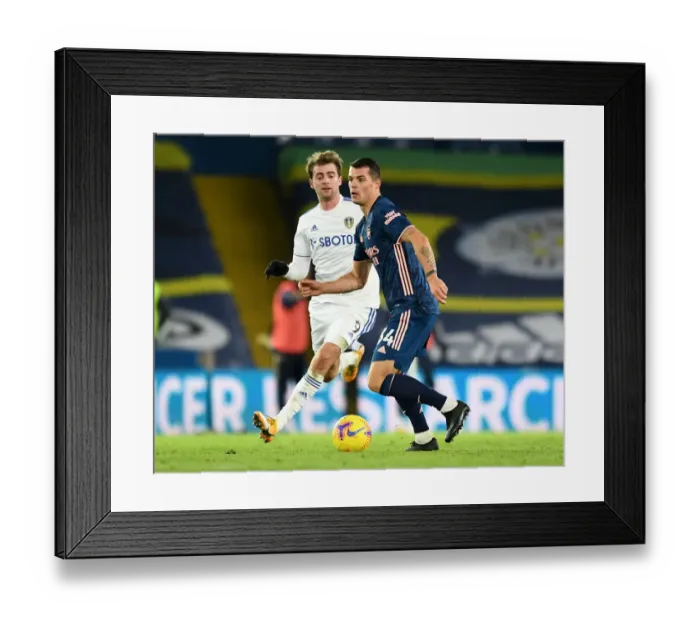 Framed Print : Xhaka vs Bamford: Intense Battle in Leeds United vs Arsenal Premier League Clash