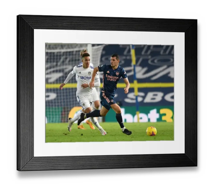 Framed Print : Xhaka vs Rodrigo: Intense Battle in Leeds United vs Arsenal Premier League Clash