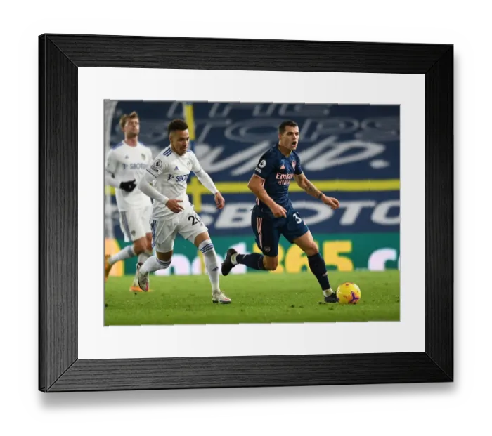 Framed Print : Xhaka vs Rodrigo: A Fierce Battle in Leeds United vs Arsenal Premier League Clash (2020-21)