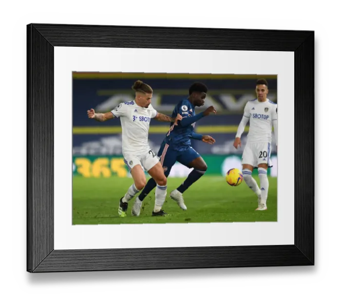 Framed Print : Leeds United vs. Arsenal: Bukayo Saka Faces Off Against Kalvin Phillips
