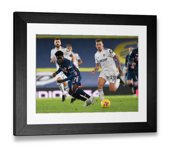 Framed Print : Bukayo Saka vs. Kalvin Phillips: Intense Battle at Elland Road - Leeds United vs. Arsenal, Premier League 2020-21